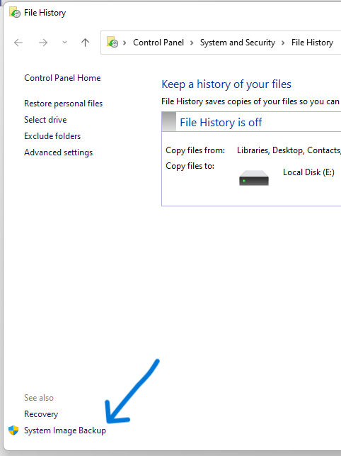 The System Image Backup link is located in the bottom-left of the File History page in Control Panel.